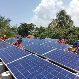 A group installing rooftop solar panels